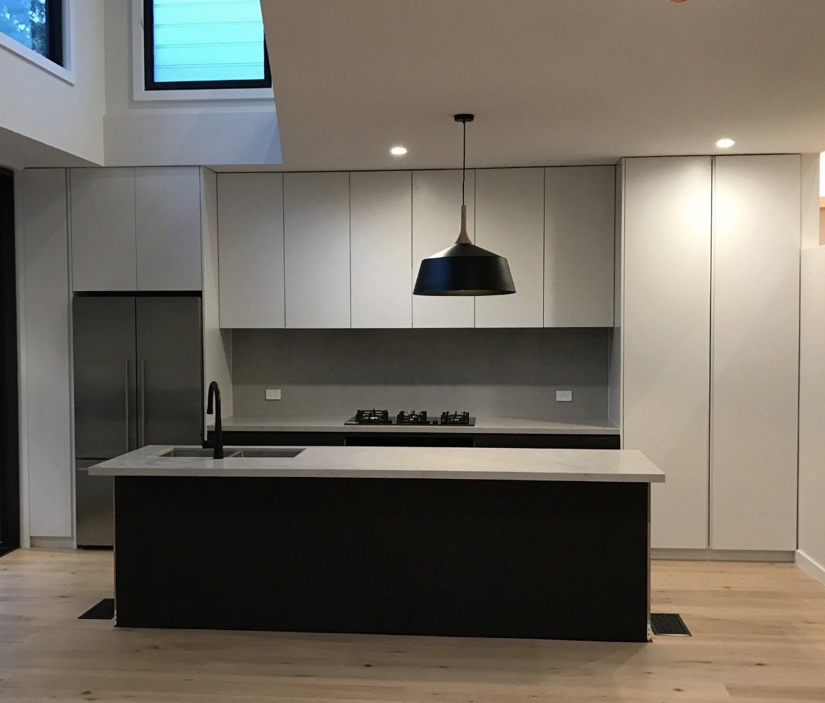 Handleless Kitchen with Black Island — Cabinets by Oaktree custom cabinetry