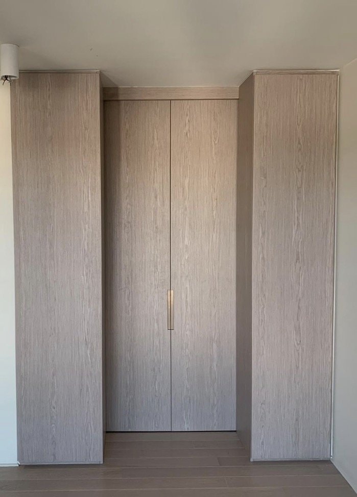 Bi-Fold Wardrobe in Timber-Tone Finish — Cabinets by Oaktree custom cabinetry